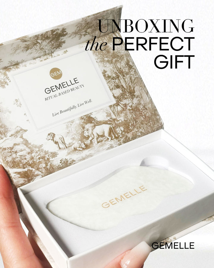 GEMELLE White Jade Gua Sha Tool in decorative box with 'Unboxing the Perfect Gift' text.