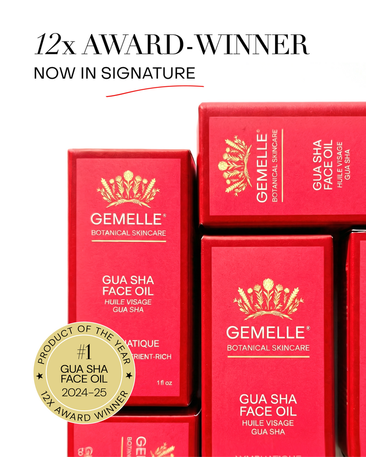 GEMELLE Signature Pink and Red boxes sacked with GEMELLE Gua Sha Face Oil with gold award badge on a white background